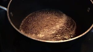 Maple syrup boiling in a pot on the stovetop