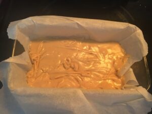maple fudge in loaf pan lined with parchment paper