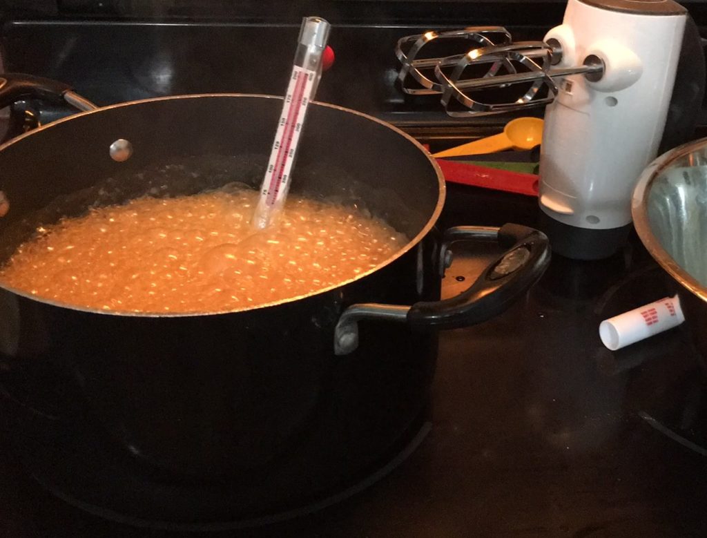 Maple syrup boiling to make the best maple fudge using a candy thermometer