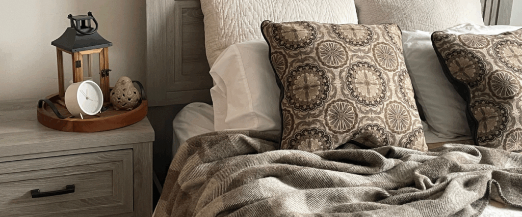 dark grey and light grey wool blanket on bed