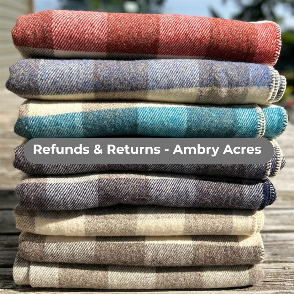 Stack of wool checkered blankets sharing our refunds & returns policy at Ambry Acres