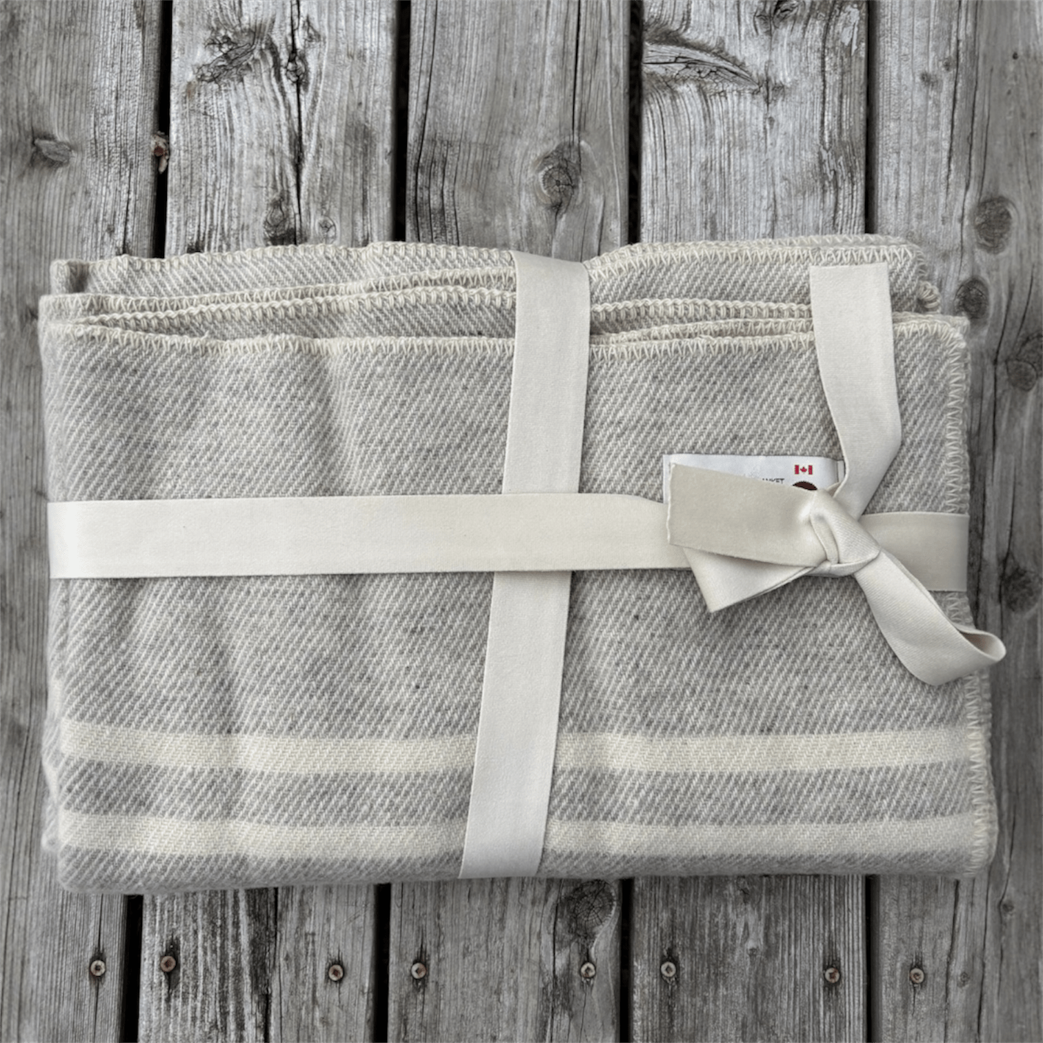 Light grey tweed with three stripes. 100% wool blanket from our sheep's wool